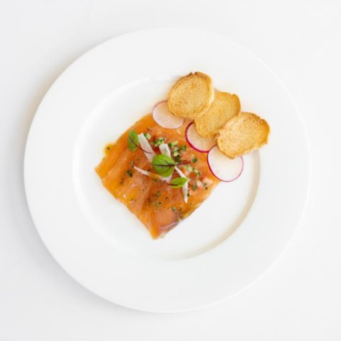 HOUSE CURED SALMONAtlantic Salmon cured in White Wine with Lemon Jelly, Pickle Fennel, Cucumber, Tobiko Caviar, Crostini and Soft Herbs (GF, NF, DF)